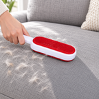 Reusable self-cleaning lint brush used on a gray sofa